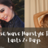 A horizontal brand banner featuring two contrasting photo panels side by side, as referenced in the file 5 Dreamy Ways to Get Elegant Loose Waves Overnight (2).jpg. Running through the middle of the collage, a semi-transparent dark grey horizontal band contains white, whimsical script text stating: "Loose wave Hairstyle That Lasts 2+ Days". The panels include: Left Panel: A close-up portrait of a smiling woman with dark brown hair looking down toward the camera. She has long eyelashes, red lipstick, and large silver hoop earrings while wearing a black leather jacket. Right Panel: A back view of a woman with long blonde hair styled in uniform, glamorous Hollywood-style waves. Her arms are raised above her head against a background of soft cream-colored curtains, illuminated by warm, glowing sunlight.