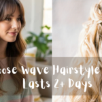 cross the center of the image, a wide, semi-transparent grey horizontal banner features white handwritten-style script text that reads: "Loose wave Hairstyle That Lasts 2+ Days". The panels include: Left Panel: A side profile view of a smiling woman sitting in a bright room. Her long brunette hair is styled with wispy curtain bangs and soft, voluminous waves that fall past her shoulders. She is wearing a pastel-striped pink and sage green knit sweater. Right Panel: A rear close-up view of a woman with long blonde hair styled into an elegant half-up twist secured with a delicate, pearl-embellished bridal hairpiece. Her wavy hair cascades down her back, and she is wearing a light purple or lavender gown.