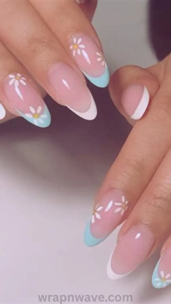 Short natural nails with soft pastel French tips adorned with hand-painted white flower stems and green leaves. Ideal inspiration for French tip flower nail trends and subtle floral manicures.