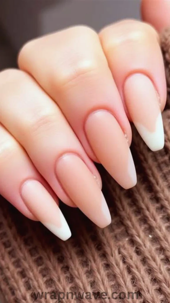 Close-up of hands with long, almond-shaped nails featuring a mix-and-match polka dot manicure in red, black, nude, and white, showcasing varied designs like dotted French tips, full-coverage patterns, and solid accent nails.