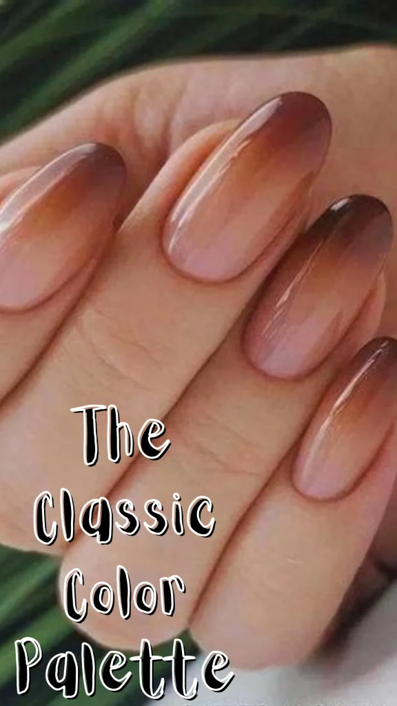 Close-up of glossy, almond-shaped fingernails featuring a smooth brown-to-nude ombré gradient art, with bold overlay text reading "The Classic Color Palette".